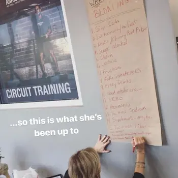 Tracy writing a "What Causes Bloating" chart